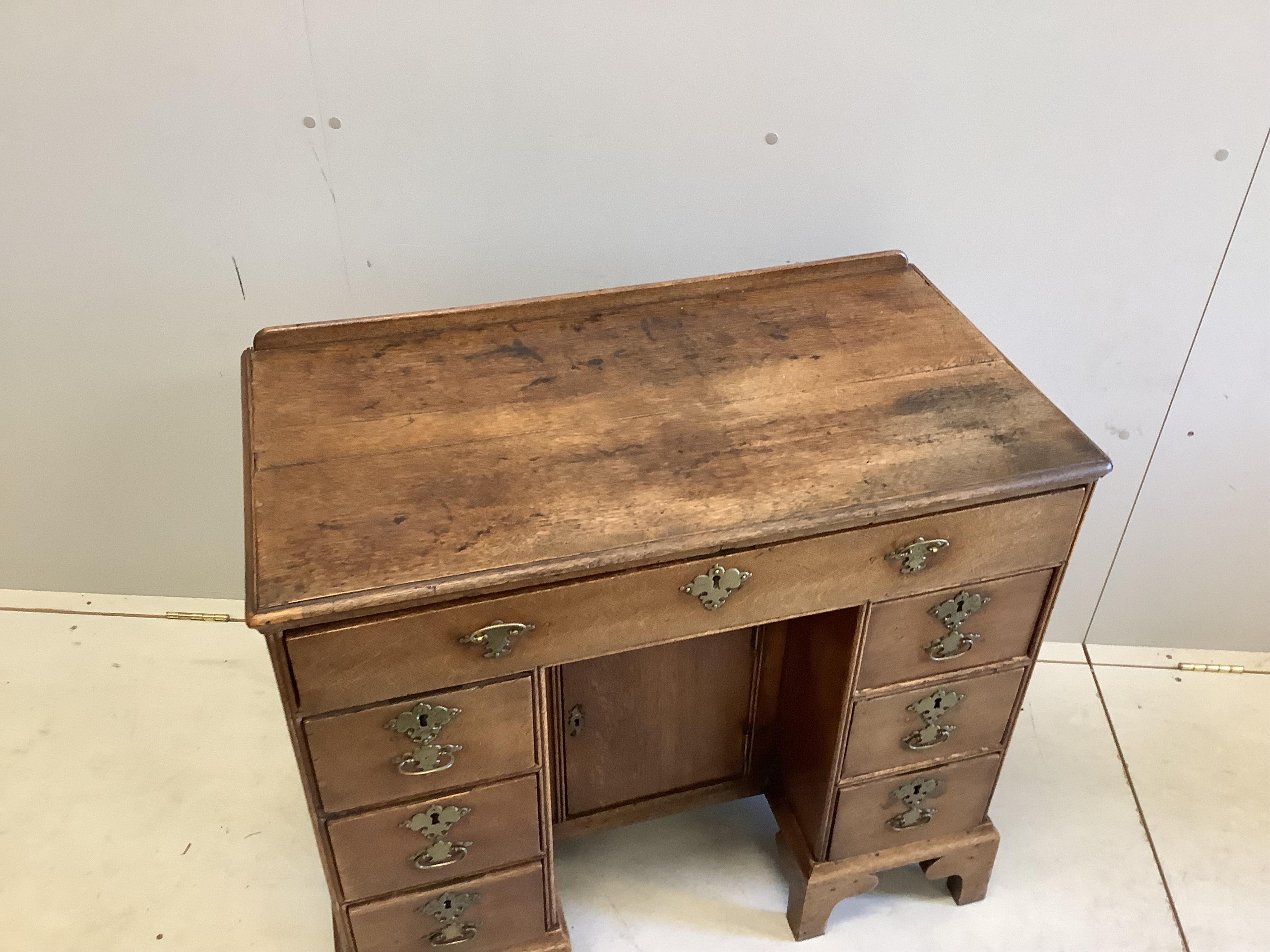 A George lll Provincial oak kneehole desk, width 86cm, depth 46cm, height 78cm. Condition - fair